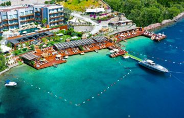 <p>Located in the heart of Bodrum's stunning Gündoğan Bay, this luxurious summer residence offers a waterfront experience with a private beach within the complex - 